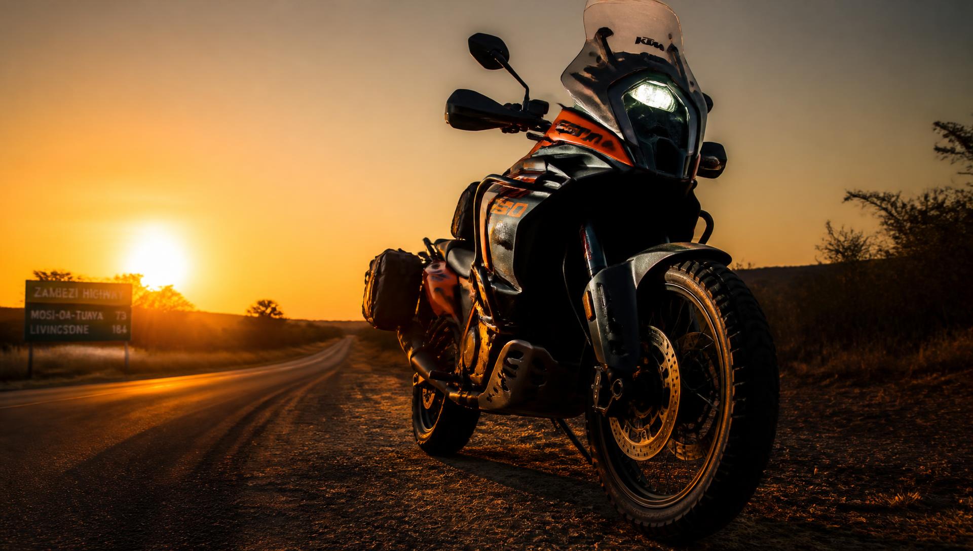 Adventure motorcycle on the Zambezi highway at sunset